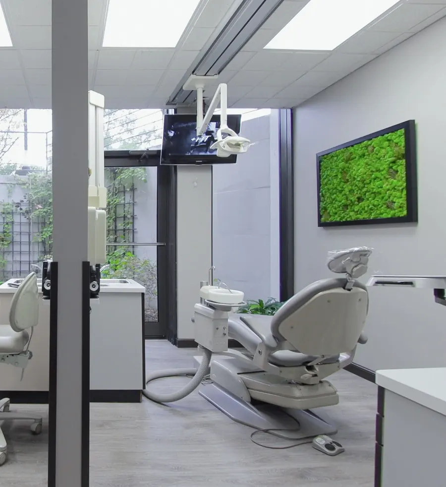 A treatment room with a living moss panel on the wall.