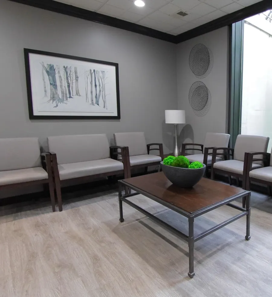Waiting room chairs beneath a framed birch-tree print.